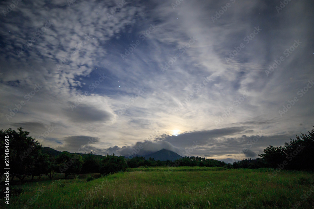 Cloud covered Mt. Daisen behind moonlit field