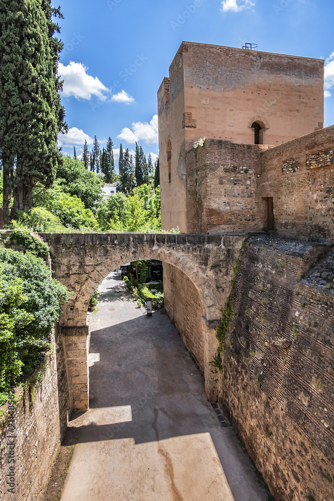 Panorama of the famous Alhambra - mediaeval Moorish palace and fortress complex. Fortress Wall. Alhambra originally constructed as a small fortress in AD 889. Granada, Andalusia, Spain.