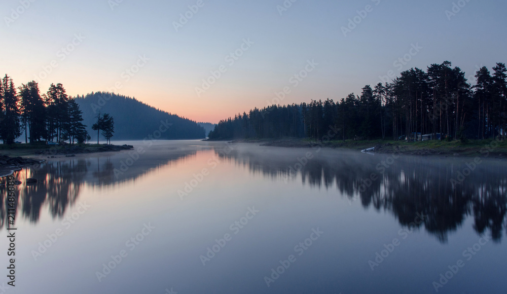 Magic sunrise by the dam lake in Rhodope mountain, Bulgaria. 