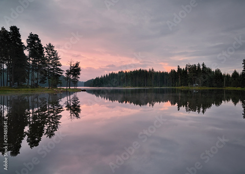 Magic reflections in the water of the dam. Sunrise in Rhodope mountain, Bulgaria. 
