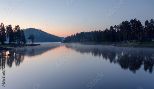 Magic sunrise by the dam lake in Rhodope mountain, Bulgaria. 