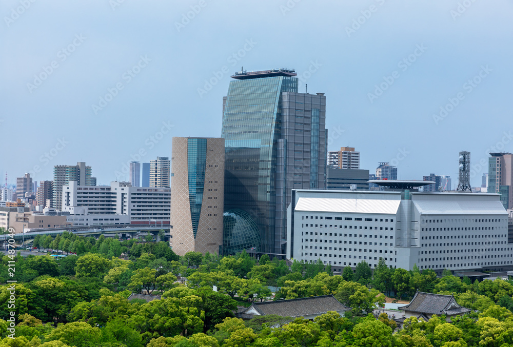 Wall and moat around Osaka Castle and skyscrapers of Osaka Busin Wall and moat around Osaka Castle and skyscrapers of Osaka Busin