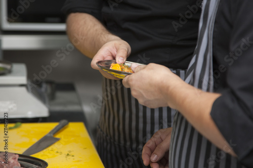 Hands chef preparing a dish of peaches