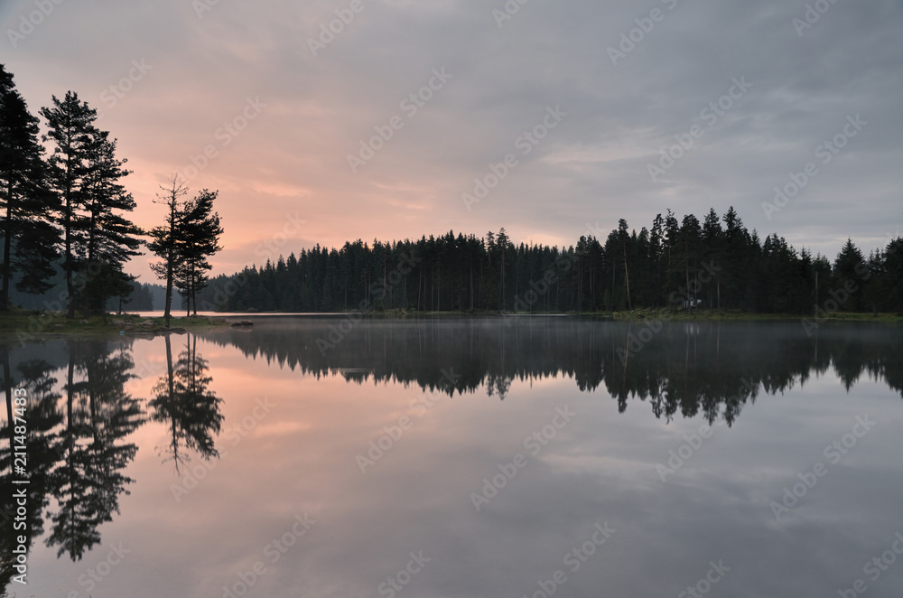 Magic reflections in the water of the dam. Sunrise in Rhodope mountain, Bulgaria. Magic reflections in the water of the dam. Sunrise in Rhodope mountain, Bulgaria.