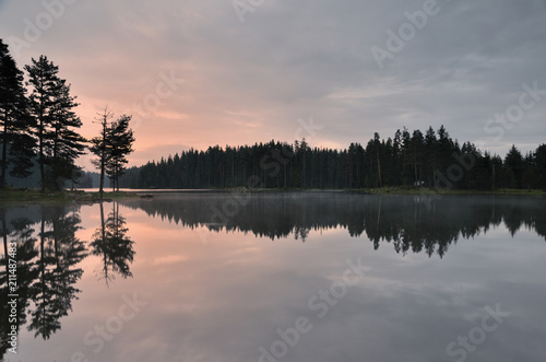 Magic reflections in the water of the dam. Sunrise in Rhodope mountain, Bulgaria. 