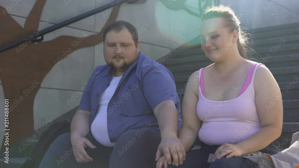 obese-man-tenderly-holding-his-girlfriend-hand-true-feelings-first