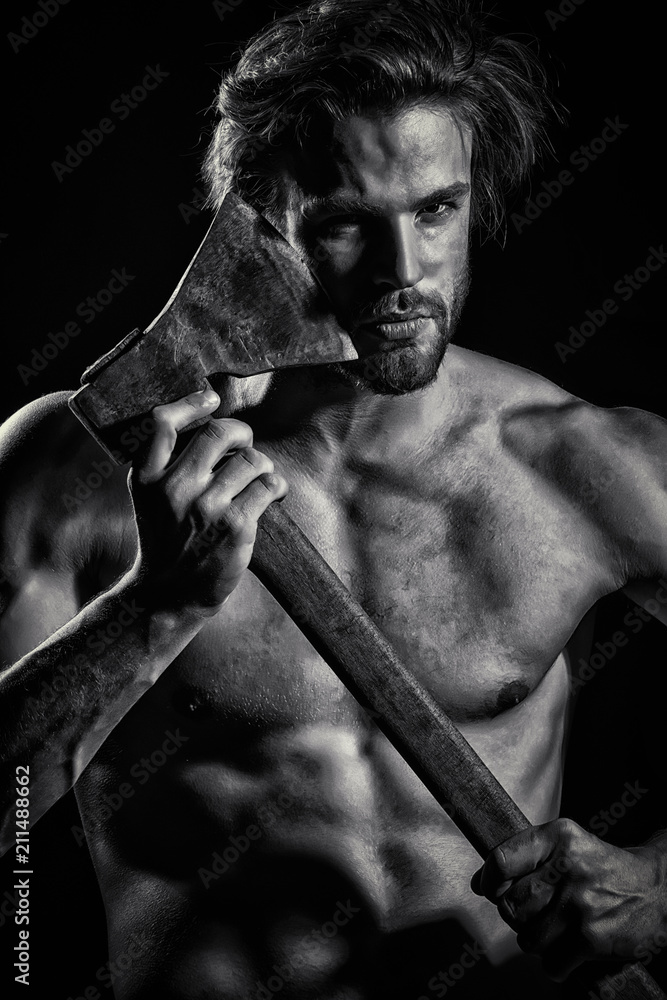 Strength and power. Young guy with ax. Strong man concept. Straight razor.  Danger and passion. Attractive