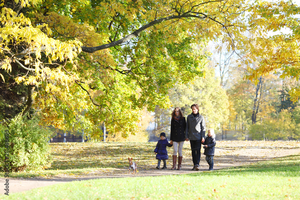 Family with children walking in autumn park Family with children walking in autumn park