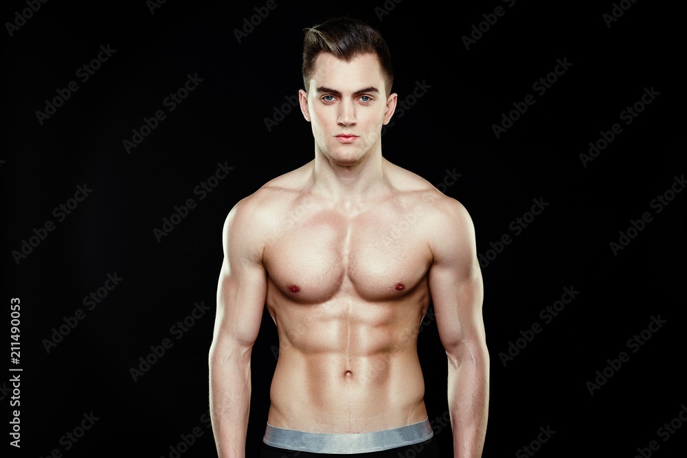 Fototapeta premium Handsome sporty young man in underwear posing on dark background