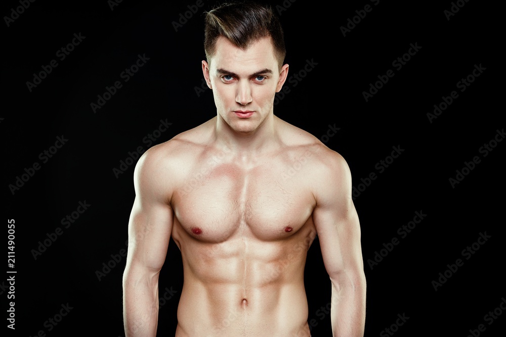 Handsome sporty young man in underwear posing on dark background Handsome sporty young man in underwear posing on dark background