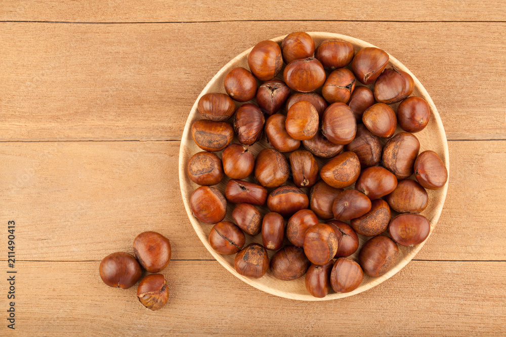 Top view angle of chestnut in wooden plate Top view angle of chestnut in wooden plate