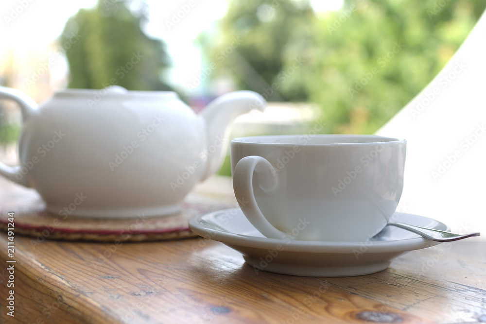 White tea set on outdoor background
