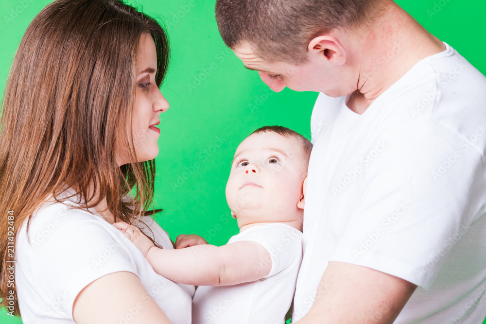 Portrait of young couple and their cute baby Portrait of young couple and their cute baby