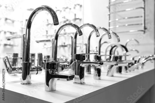 Rows of new faucets in plumbing shop, closeup