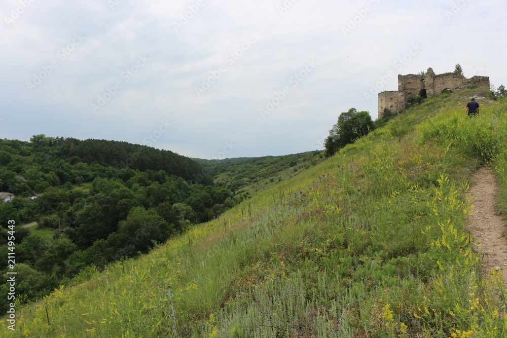  Landscapes with a view of the ruins of an ancient fortress among the hills.