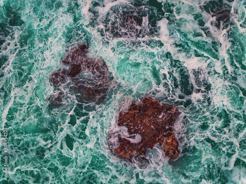  Aerial view of rocky coastline with crashing waves