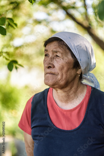 portrait of a sad elderly woman in the garden
