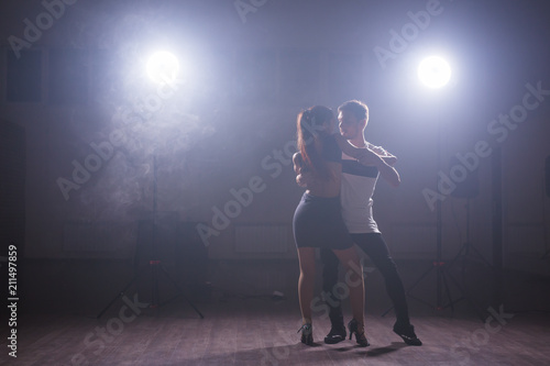 Young couple dancing latin dance Bachata, merengue, salsa. Two elegance pose in dance class