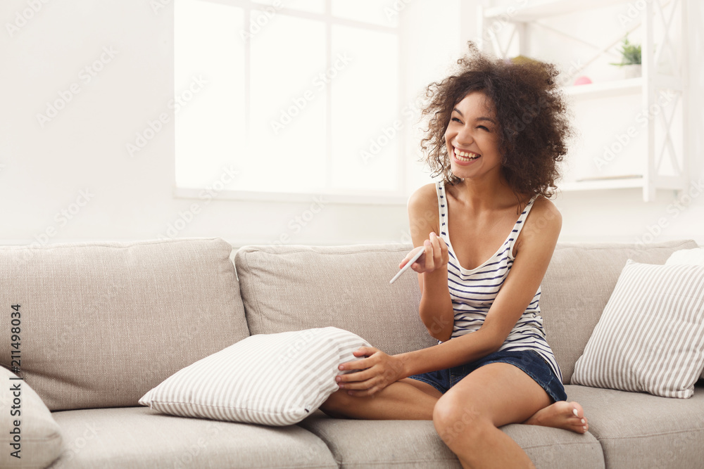 Excited girl reading results of pregnancy test Excited girl reading results of pregnancy test
