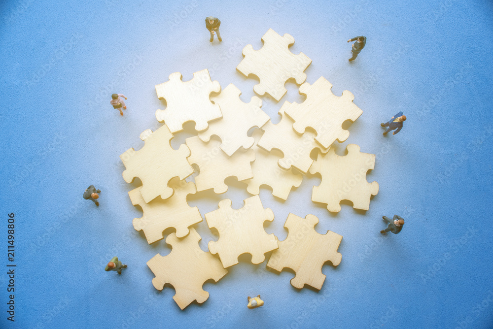 Fototapeta premium Miniature on wood jigsaw, Business concept