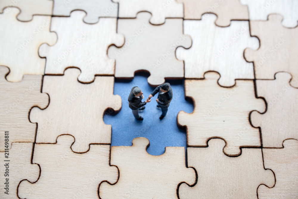 Fototapeta premium Miniature on wood jigsaw, Business concept