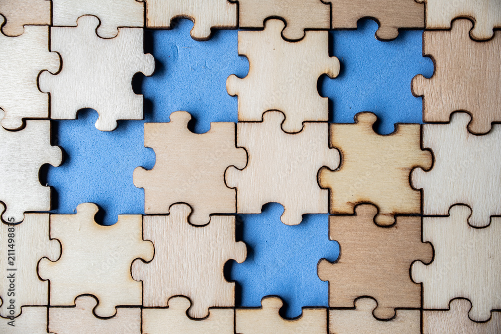 Wood jigsaw puzzle on blue background, business concept Wood jigsaw puzzle on blue background, business concept