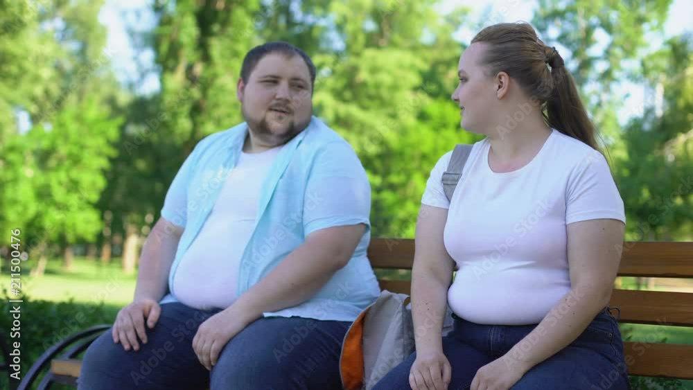 Erudite obese man telling interesting stories to pretty girl, self-confidence Erudite obese man telling interesting stories to pretty girl, self-confidence
