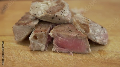 Medium roasting fillet of tuna. Healthy Tuna steak cutted. Slow motion closeup photo