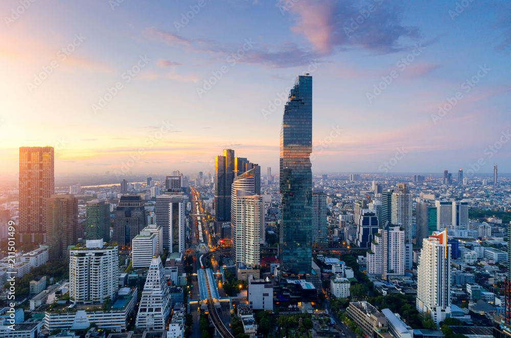 Naklejka premium Aerial view of Bangkok modern office buildings, condominium, living place in Bangkok city downtown with sunset scenery, Bangkok is the most populated city in Southeast Asia.Bangkok , Thailand