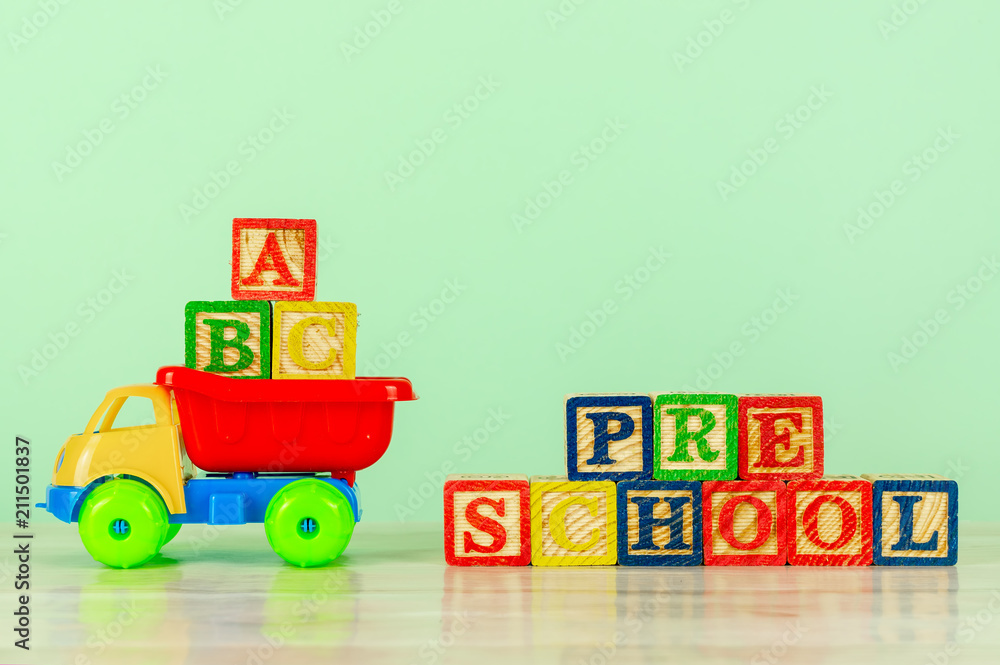 Colorful toy truck with alphabet blocks arrangement of Pre School. Pre school, back to school concept. Colorful toy truck with alphabet blocks arrangement of Pre School. Pre school, back to school concept.