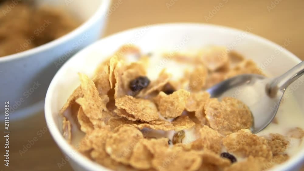 Fresh and healthy caw milk slowly in the white bawl. Healthy food and flakes at the background. Serving breakfast from quality products ( flakes and oat ) as the healthy meal for morning. Fresh and healthy caw milk slowly in the white bawl. Healthy food and flakes at the background. Serving breakfast from quality products ( flakes and oat ) as the healthy meal for morning.