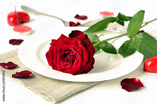 Romantic dinner with red roses and candles, selective focus