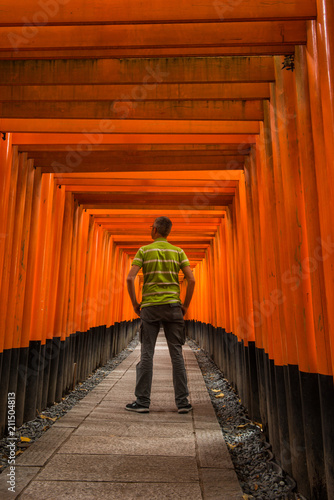 Man inside a Japanese Torii tunnel