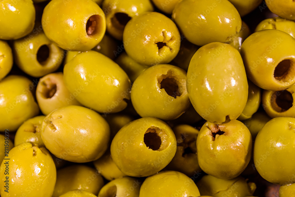 Background of the fresh marinated green olives Background of the fresh marinated green olives