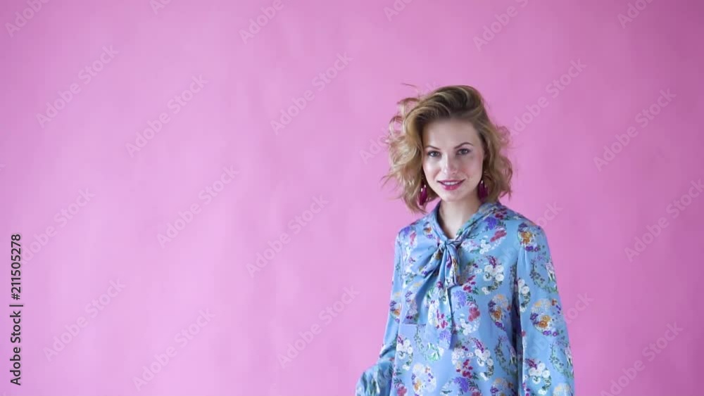 cheerful positive blonde girl posing for the camera in a photo Studio on a pink background cheerful positive blonde girl posing for the camera in a photo Studio on a pink background