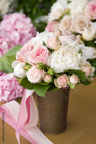 Brides bouquet with peony roses and ribbon.