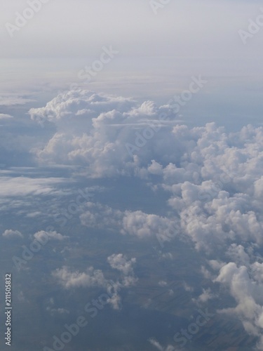 Tranquil Beautiful View From Plane Window at Blue Sky over White Clouds