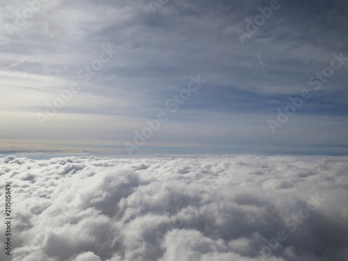 Tranquil Beautiful View From Plane Window at Blue Sky over White Clouds