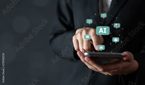 Businessman holding smartphone and touch sign text AI (Artificial Intelligence). Future Technology Concepts.