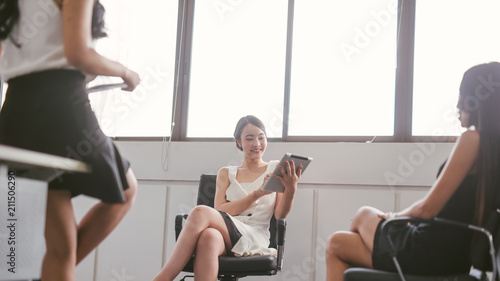 Smiling young asian business woman working in office.