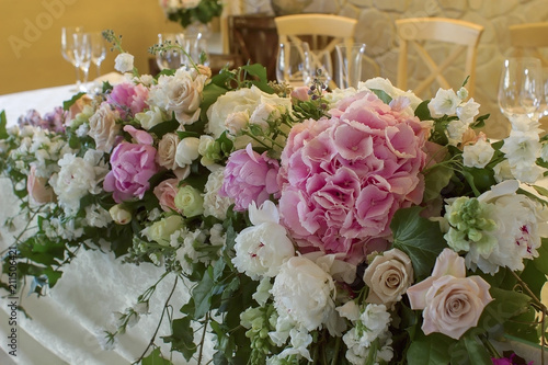 Wedding table decoration with glases flowers bouqet.