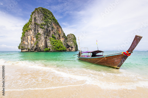 Beautiful seascape with limestone rock and longtail boat