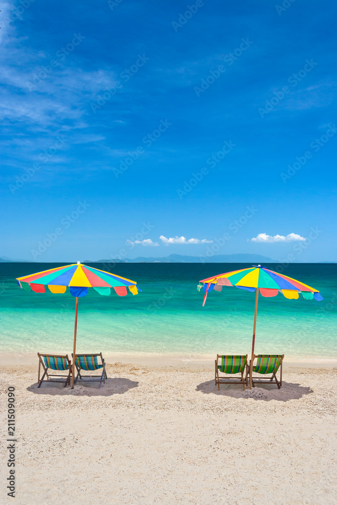Colorful beach chairs with umbrellas on a sunny day.