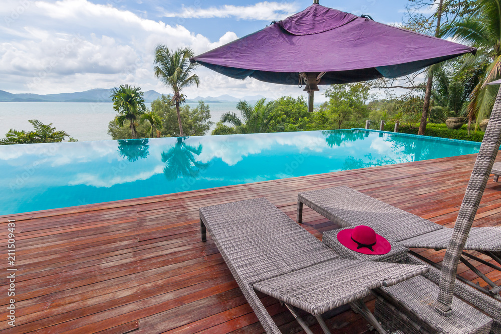 Beach chairs by the swimming pool with beautiful sea horizon view, Phuket Thailand