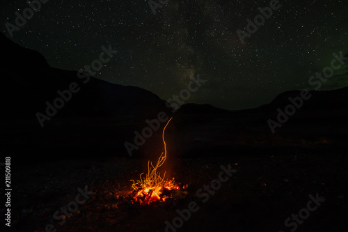 Campfire under the stars in campsite in Greenland