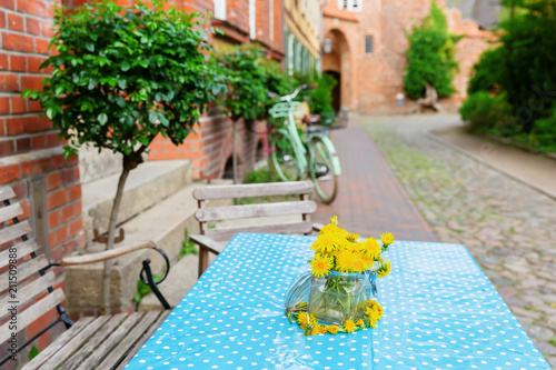 Fototapeta Naklejka Na Ścianę i Meble -  dandelions in a canning jar as table decoration