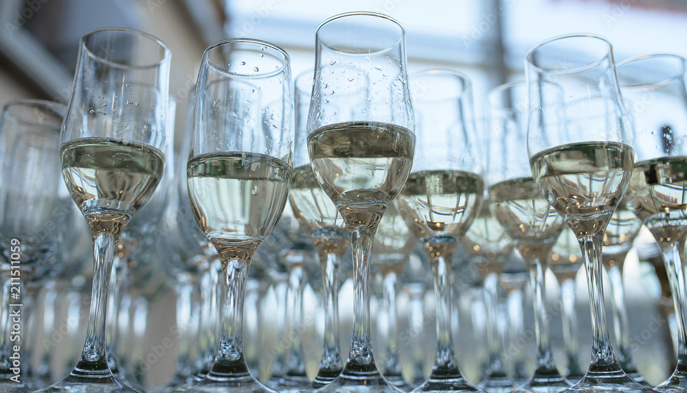 View from below of half full champagne or bubbly flutes, a typical wedding reception or party welcome for the guests View from below of half full champagne or bubbly flutes, a typical wedding reception or party welcome for the guests