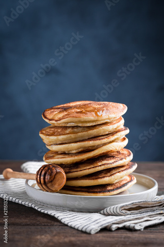 Stack of homemade pancakes  on blue background, copy space