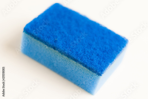 One blue color sponge for dishwashing on white background. Cleaning concept