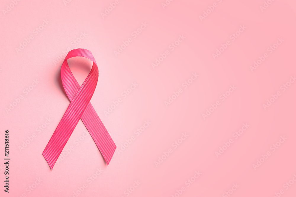 Pink ribbon on color background, top view. Cancer awareness Pink ribbon on color background, top view. Cancer awareness
